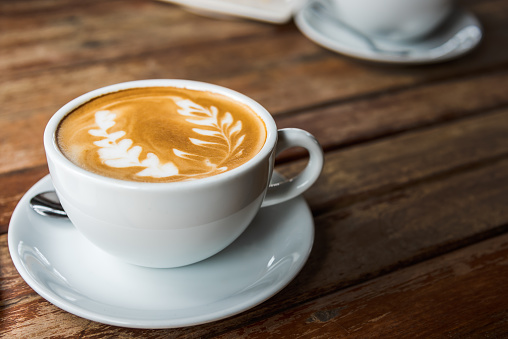 Hot coffee latte with beautiful latte art, close up and selective focus image.