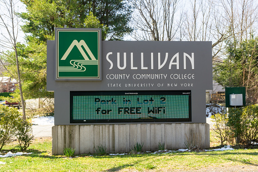 Loch Sheldrake, NY / United States - April 19, 2020: landscape view of the entrance to Sullivan County Community College
