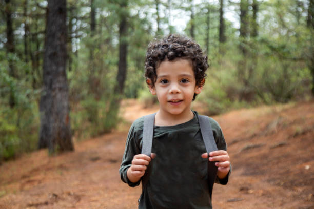 istock Child walking in the woods 1266627518