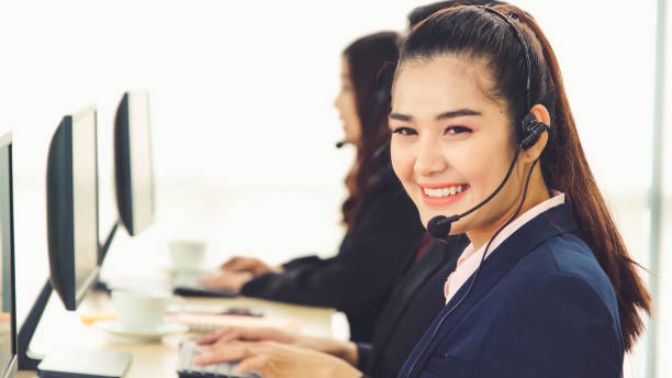 istock Business people wearing headset working in office 1266627909