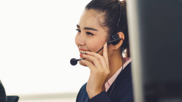 istock Business people wearing headset working in office 1266629326