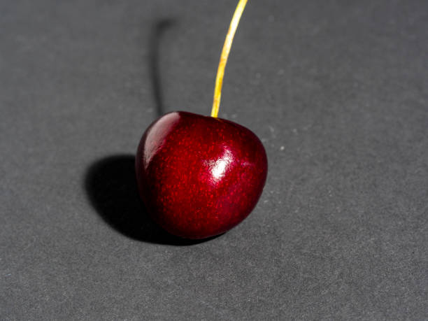 istock bright juicy ripe cherry berry isolated on a dark background 1266629992