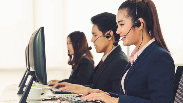 istock Business people wearing headset working in office 1266630027