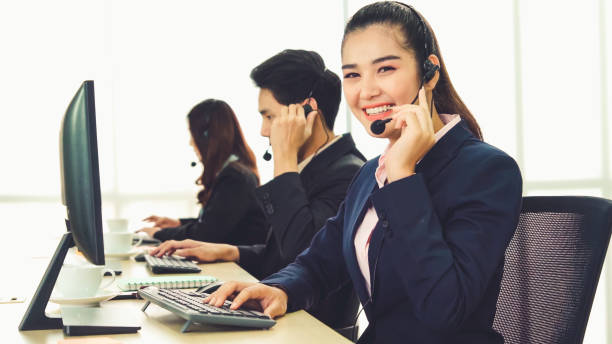 istock Business people wearing headset working in office 1266630484