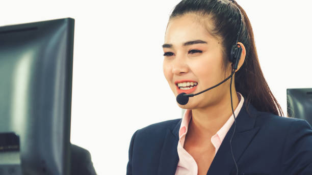 istock Business people wearing headset working in office 1266630659