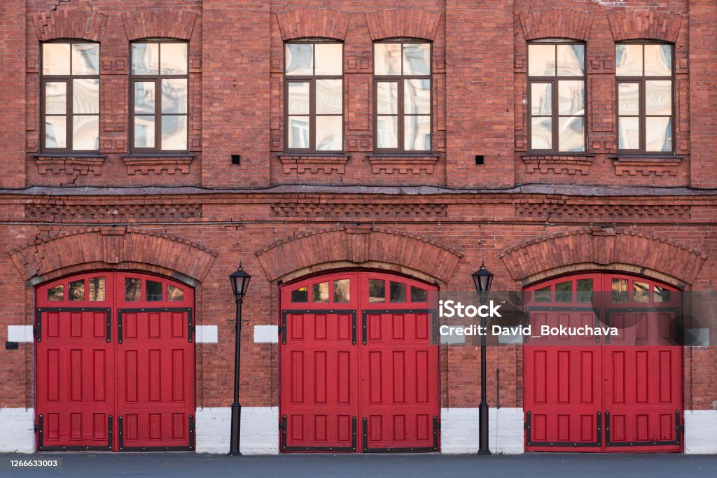 Fire station, an old historic brick building Fire station, an old historic brick building (1880s) with red gates. Fire department in Vasilyevsky Island, St. Petersburg, Russia. Fire Station Stock Photo