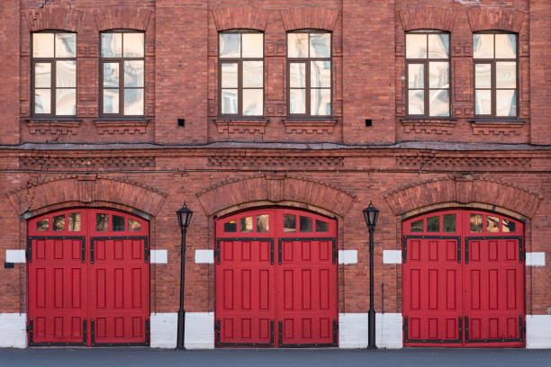 Fire station, an old historic brick building Fire station, an old historic brick building (1880s) with red gates. Fire department in Vasilyevsky Island, St. Petersburg, Russia. fire station stock pictures, royalty-free photos & images