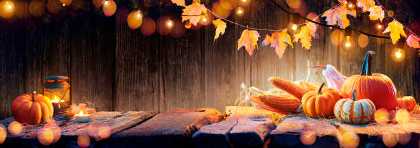 istock Thanksgiving Table - Pumpkins And Corncobs On Wooden Plank With Garlands 1266633077