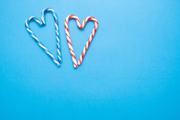 Christmas love, candy canes in heart shape. Holiday greetings with copy space.