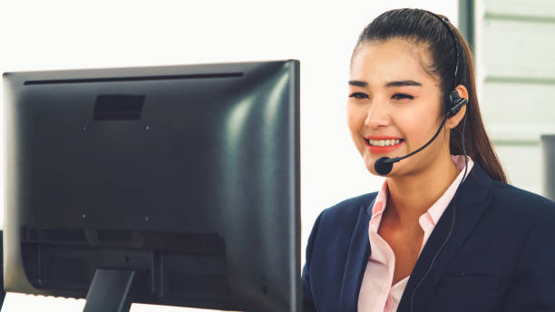 istock Business people wearing headset working in office 1266634151