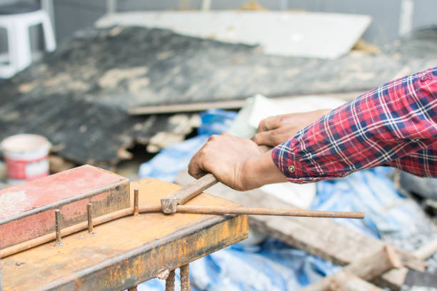 istock The hands of the builder are bending the iron at site construction 1266634325