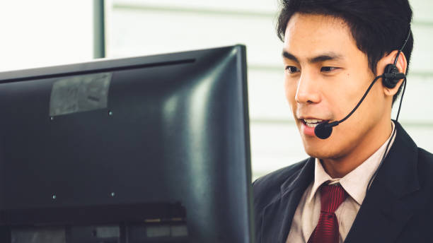 istock Business people wearing headset working in office 1266635439