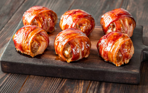 Bacon wrappped meatballs Bacon wrappped meatballs stuffed with cheese bacon wrapped stock pictures, royalty-free photos & images