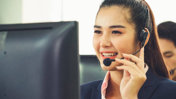 istock Business people wearing headset working in office 1266637432
