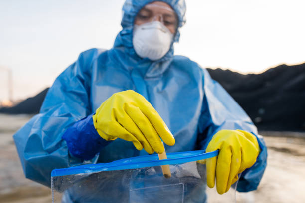 istock Ecologist putting flask with sample of water from dangerous area into packet 1266639495
