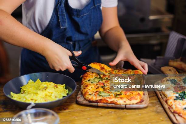 Chef Hands Cuts Pizza With Kitchen Scissors Stock Photo - Download Image Now - Scissors, Kitchen, Pizza