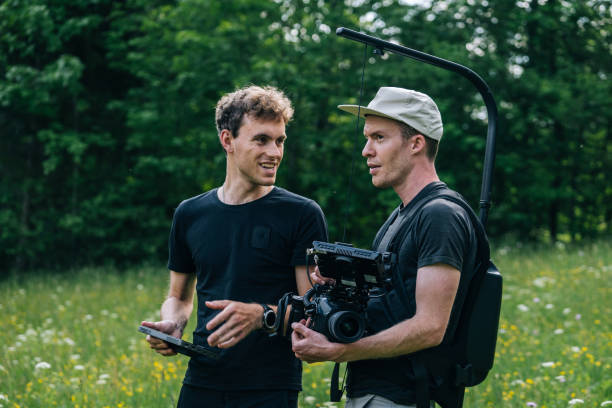 istock Cinematographers work together with filming equipment 1266641019