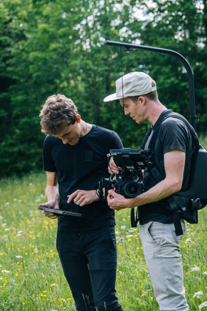 istock Cinematographers work together with filming equipment 1266641089