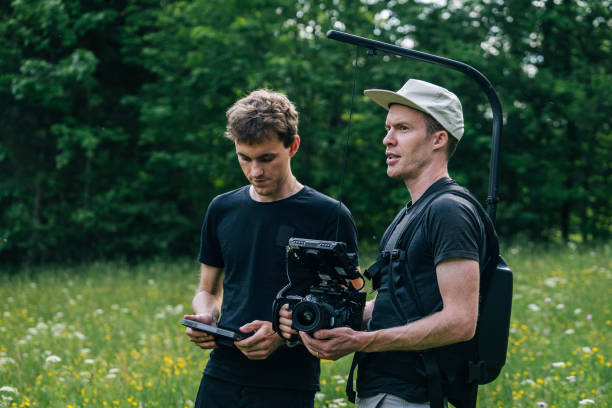 istock Cinematographers work together with filming equipment 1266641902