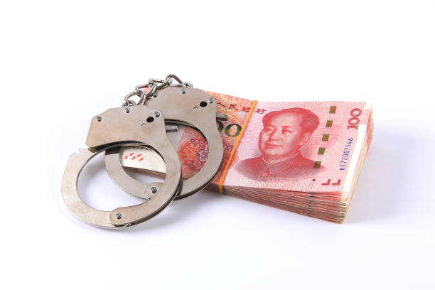 istock Chinese money and handcuffs 1266643012