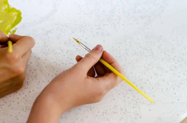 istock Woman with child paint with paints on canvas 1266643386