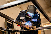 Senior worker working with welding tool
