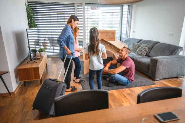 istock Multi-ethnic family playing with cardboard hotel at home during quarantine 1266644691