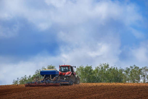 istock Farmer in tractor preparing land with seedbed cultivator 1266646901