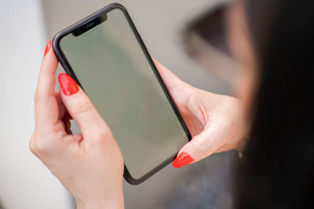 istock young woman using her smart phone outdoors 1266648139