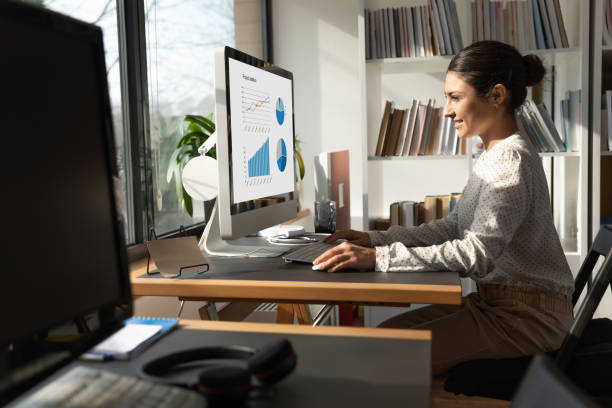 istock Happy indian female employee working on PC in office 1266648561