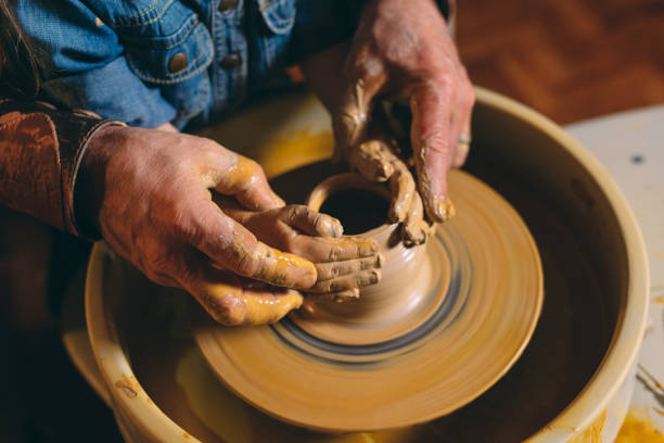 istock Pottery workshop. Grandpa teaches granddaughter pottery. Clay modeling 1266650300