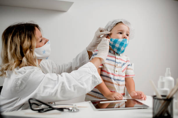 istock Cute little boy visiting the doctor. 1266650641