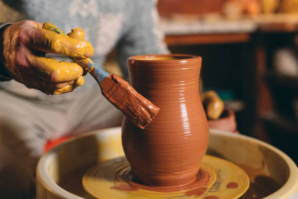 istock Pottery workshop. A senior man makes a vase of clay. Clay modeling 1266650806