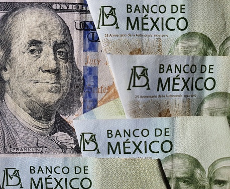 American 100 dollars bill and Mexican banknotes of 200 pesos