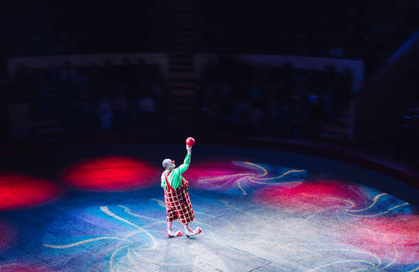 Performance of a Clown with a ball at the Circus. stock photo