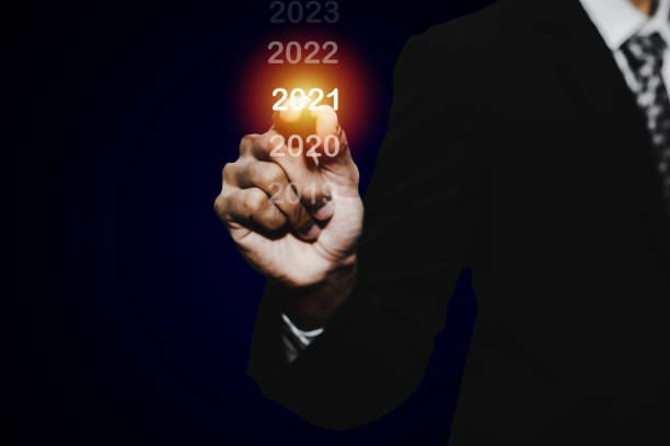 istock Goal target. businessman hand touching and pointing with pen on year 2021 with virtual screening on dark background, change from 2010 to 2021, strategy, business planning and happy new year concept 1266653754