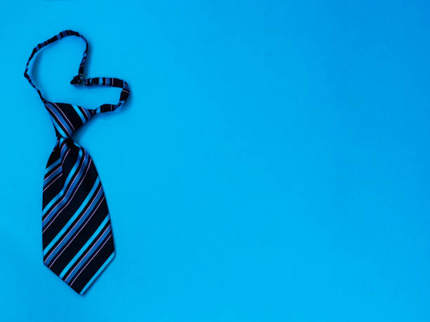 istock Blue heart-shaped striped tie on a blue background. Copy space 1266656106
