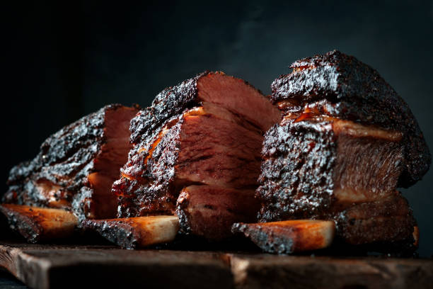 istock Chopping board with Smoked beef brisket ribs, Classic Texas BBQ 1266657596