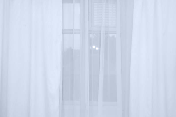 istock White translucent tulle and curtains on the window close-up. 1266661671