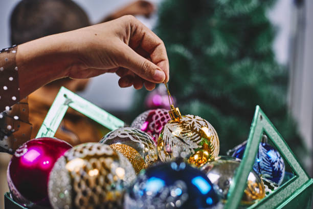 istock Son helps mom to decorate Christmas tree 1266663093