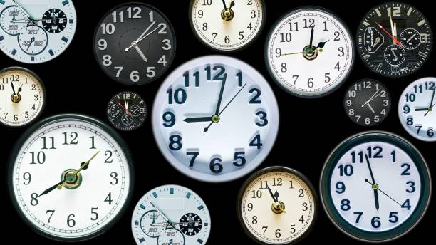 istock Many time clock faces appear showing different  time. Various clocks in busy time flow concept. 1266663872