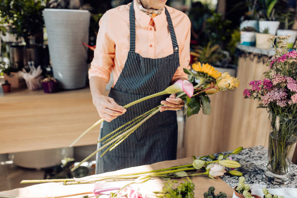 istock Florist making a beautiful flower bouquet 1266664139