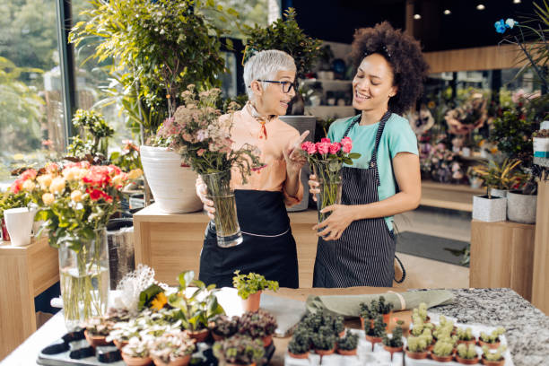 istock Two florists enjoying working at their flower store 1266665438