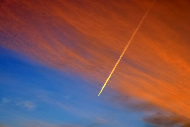 istock Aircraft condensation contrails in the blue sky inbetween some clouds 1266666821