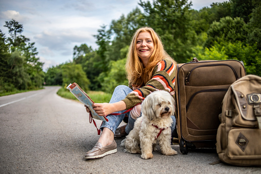 The girl is traveling with her dog