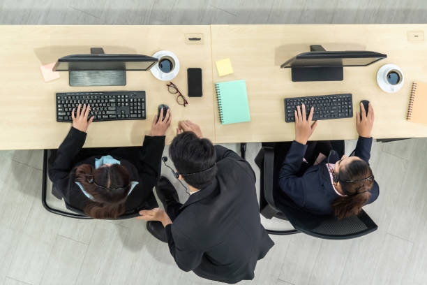 istock Business people wearing headset from top view in office working with computer 1266667719