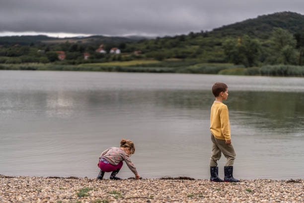 istock Kids playing on lakeshore 1266669619