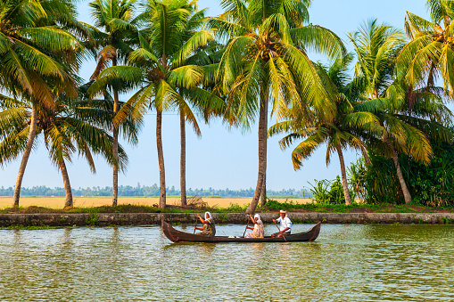 ALAPPUZHA, INDIA - MARCH 18, 2012: Unidentified people sailing boat in Alappuzha backwaters in Kerala state in India