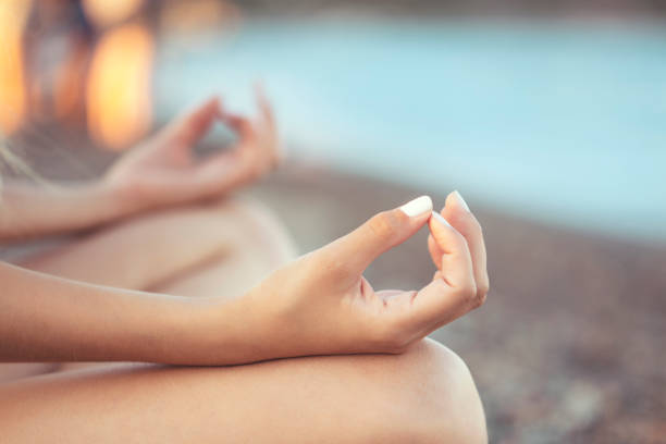 young woman doing yoga on the beach