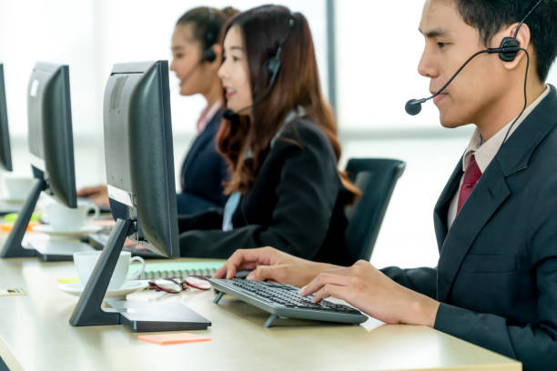 istock Business people wearing headset working in office 1266674979
